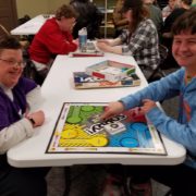 Volunteer playing the board game Sorry!